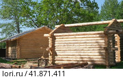 Wooden log building, housing. Log cabin. Wood House exterior. Country Green forest on background. Built a cottage on construction site. Wooden frame of the home from bar. Production. Carpentry concept. Стоковое видео, видеограф Марина Демидюк / Фотобанк Лори