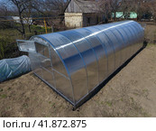 Polycarbonate greenhouse assembled from parts, prefabricated greenhouse. Стоковое фото, фотограф Леонид Еремейчук / Фотобанк Лори