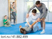 Woman student, with help of male teacher, completes neutralization of opponent. Стоковое фото, фотограф Яков Филимонов / Фотобанк Лори