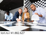 People trying together to find solution of conundrum in quest room. Стоковое фото, фотограф Яков Филимонов / Фотобанк Лори