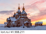 Large wooden cathedral. A beautiful Orthodox church in the Far North of Russia in the Arctic. Cold winter weather. Snowdrifts in the yard and snow on the roof of the building. Anadyr, Chukotka, Russia. Стоковое фото, фотограф Андрей Степанов / Фотобанк Лори