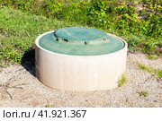 Sewer manhole of rural septic tank with green plastic cover, sewage system. Стоковое фото, фотограф FotograFF / Фотобанк Лори