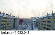Petrozavodsk, Russia, January 5, 2024: smoke and steam from the chimneys of residential multi-storey buildings rises in severe frost -27 degrees Celsius. Housing and communal services and heating. Редакционное видео, видеограф Юлия Петровская / Фотобанк Лори