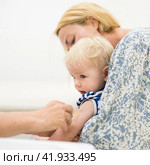 Child beeing vaccinated by pediatrician in presence of his mother. Preventive vaccination against Diphtheria, whooping cough, tetanus, hepatitis, haemophilus influenzae, pneumococcus, poliomyelitis. Стоковое фото, фотограф Matej Kastelic / Фотобанк Лори