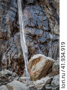 Man at waterfall in the mountains. Стоковое фото, фотограф Юрий Поздников / Фотобанк Лори