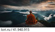 Buddhist monk master is meditating at the top of the cliff at dusk for the new year. Buddhist monk sitting in nirvana on top of mountain above clouds early morning. AI. Стоковое AI-изображение, AI-художник Sergey Grishin / Фотобанк Лори