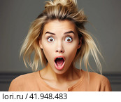 A blonde girl with a surprised look and an open mouth looks at the camera. The concept of strong surprise. Generated by AI. Стоковое AI-изображение, AI-художник Ярославский Максим / Фотобанк Лори