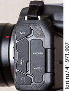 Krasnodar, Russia - December 28, 2023: side view of the Canon eos  R7 mirrorless camera with rubber connector covers for connecting various devices. Редакционное фото, фотограф Андрей С / Фотобанк Лори