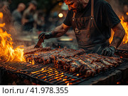Gaucho cooking the meat on the fire, making the barbecue on the coals, Photos and menus of cafes and restaurants, Magazines. Стоковое AI-изображение, AI-художник Ирина Ручушкина / Фотобанк Лори