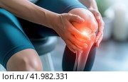 A person with knee pain sitting on a chair, AI. Стоковое AI-изображение, AI-художник Сергей Старуш / Фотобанк Лори