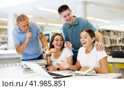 Mature man tells a group of young students to be quiet. Стоковое фото, фотограф Яков Филимонов / Фотобанк Лори