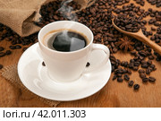 Cup of coffee with froth on a wooden table. Стоковое фото, фотограф Александр Калугин / Фотобанк Лори