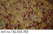 Scrumptious pizza with melting cheese, slices of sausage, and fresh cucumbers. Стоковое видео, видеограф Андрей Знаменский / Фотобанк Лори