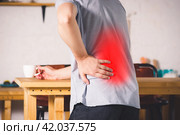 Back pain, kidney inflammation, man suffering from backache at home. Стоковое фото, фотограф Станислав Тарко / Фотобанк Лори