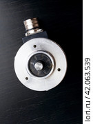 Metal encoder on a black wooden table. Стоковое фото, фотограф Аксенова Вера / Фотобанк Лори