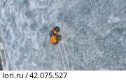 The rover climbs up on thin ice out of the water. Conquering the Arctic with Diesel Might. Vertical 9x16 Aerial Drone shot. Стоковое видео, видеограф Даниил Хабаров / Фотобанк Лори