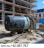 Universal compressor on construction site. Стоковое AI-изображение, AI-художник Юрий Поздников / Фотобанк Лори
