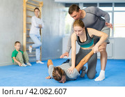 Girl student, with help of male teacher, completes neutralization of opponent. Стоковое фото, фотограф Яков Филимонов / Фотобанк Лори