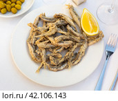 Dish with fried sardines, pilchards or anchovies in batter for traditional Spanish meal. Стоковое фото, фотограф Яков Филимонов / Фотобанк Лори
