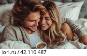 Young loving couple in the bed with cops of coffee. soft and light colors. copy space. Стоковое AI-изображение, AI-художник Юлия Гапеенко / Фотобанк Лори