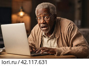 Surprised and scared elderly man looking at laptop screen in living room. Стоковое AI-изображение, AI-художник Васильева Юлия / Фотобанк Лори