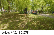 Cherepovets, Russia - May 27, 2023, Children play in the bushes in the city park playground with animators. FPV Aerial Drone Shot. Редакционное видео, видеограф Даниил Хабаров / Фотобанк Лори