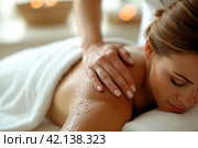 Masseur hands doing back massage to client in spa center in white room. Happy relaxed smiling brunette woman receiving traditional therapeutic shoulders and back massage therapy in luxury salon. Стоковое AI-изображение, AI-художник Ирина Михайличенко / Фотобанк Лори