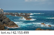 Madeira Island.  Panoramic view of the black volcanic coastline with surf near Funchal. Copy space. Стоковое фото, фотограф Роман Дзюбало / Фотобанк Лори