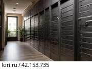 Grey steel Mailboxes in an apartment residential building inside. Modern rows of numbered mailbox, creative design mail backgrounds. Urban correspondence concept. Copy ad text space. Generated Ai. Стоковое AI-изображение, AI-художник Aleksandr Golubev / Фотобанк Лори