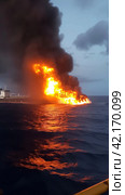 Fire on an offshore oil tanker. Стоковое AI-изображение, AI-художник Кирилл Черезов / Фотобанк Лори