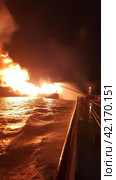 Fire on an offshore oil tanker. Стоковое AI-изображение, AI-художник Кирилл Черезов / Фотобанк Лори