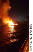 Fire on an offshore oil tanker. Стоковое AI-изображение, AI-художник Кирилл Черезов / Фотобанк Лори