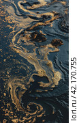 Oil spill on the surface of the reservoir. Стоковое AI-изображение, AI-художник Кирилл Черезов / Фотобанк Лори