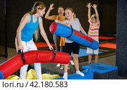 Preteen girl having fun on battle beam with other girl. Стоковое фото, фотограф Яков Филимонов / Фотобанк Лори