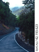 A road in a mountain hollow in summer. View from the windshield of the car. The concept of a pleasant summer trip by car. Стоковое фото, фотограф Ярославский Максим / Фотобанк Лори