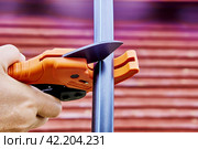 Ratcheting pipe scissor cutter is used when installing drinking and irrigation water pipes, plumber cuts HDPE pipe. Стоковое фото, фотограф Владимир Григорьев / Фотобанк Лори