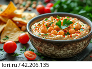 White bean humus with olive oil and smoked paprika served with nachos. Стоковое AI-изображение, AI-художник Ирина Михайличенко / Фотобанк Лори