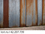 Old industrial corrugated iron industrial texture wall made of tin sheets. Grunge metal plate background. Copy ad text space. Стоковое AI-изображение, AI-художник Aleksandr Golubev / Фотобанк Лори
