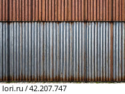 Old industrial corrugated iron industrial texture wall made of tin sheets. Grunge metal plate background. Copy ad text space. Стоковое AI-изображение, AI-художник Aleksandr Golubev / Фотобанк Лори