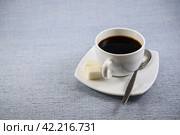Чашка чёрного кофе с сахаром на красивом блюдце на столе ранним утром. Стоковое фото, фотограф Владимир Устенко / Фотобанк Лори
