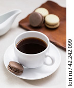Cup of coffee and macaroons on the table on a light background. Стоковое фото, фотограф Сергей Чайко / Фотобанк Лори