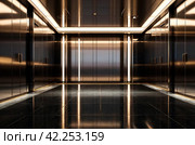 Background of interior floor of elevator platform with elevators and sunlight in business center. Modern steel elevator cabin in house or multi-apartment skyscraper. Copy space for site. Стоковое AI-изображение, AI-художник Aleksandr Golubev / Фотобанк Лори