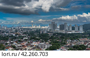 A panoramic view of the city opens from the observation deck of the Kek Lok Si Temple. Houses among green trees and skyscrapers against a blue sky and clouds. Georgetown. Malaysia. Penang. (2023 год). Стоковое фото, фотограф Вера Ивановна Кубарева / Фотобанк Лори