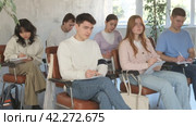 Group of concerned undergraduates listening to lecture and making notes attentively in auditorium. Стоковое видео, видеограф Яков Филимонов / Фотобанк Лори