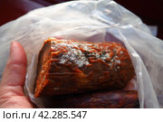 Raw smoked sausage became moldy while it was in a plastic bag. A mold or mould. The dust-like, colored appearance of molds is due to the formation of spores containing fungal secondary metabolites. Стоковое фото, фотограф Юлия Петровская / Фотобанк Лори
