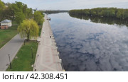 View of embankment and river reflecting blue sky with clouds. The view from above. A beautiful landscape. White clouds mirroring the surface of the dark water. Стоковое видео, видеограф Воловодов Владимир / Фотобанк Лори
