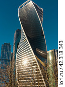 The Evolution skyscraper tower in Moscow City against a blue sky background. Russia. Moscow. Krasnopresnenskaya embankment. 03.03.2024. Редакционное фото, фотограф Ярославский Максим / Фотобанк Лори