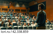 The teacher speaks to the Students in a modern classroom. The concept of education. Стоковое AI-изображение, AI-художник Ирина Ручушкина / Фотобанк Лори