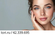 Close up portrait young beautiful woman touch her perfect smooth skin on grey studio background. Sensuality, natural beauty, plastic surgery, aesthetic medicine, cosmetology, cosmetics, skin care. Стоковое AI-изображение, AI-художник Alexander Tihonovs / Фотобанк Лори