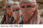 Group of People Wearing Headscarves and Holding Guns. Стоковое AI-изображение, AI-художник Юлия Гапеенко / Фотобанк Лори